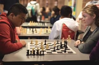Epic photo of two rivals intensely playing chess.
